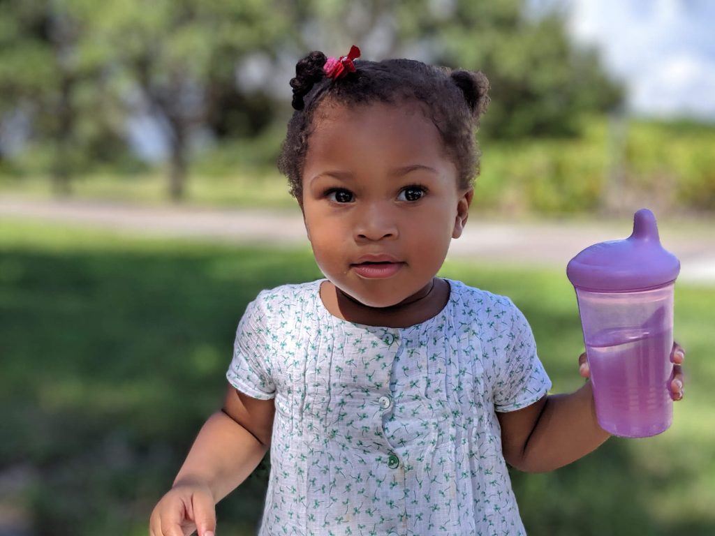 Solilyanna Purpole Bottle In Left Hand Looking To Her Left 2000x1500 80 Percent Quality TinyPng